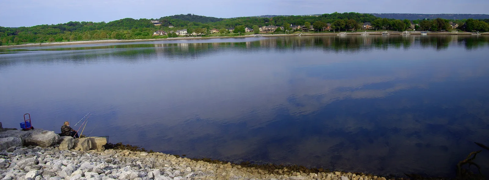A man fishes from the rocks where the Tennessee Riverpark meets Chickamauga Creek in Chattanooga.