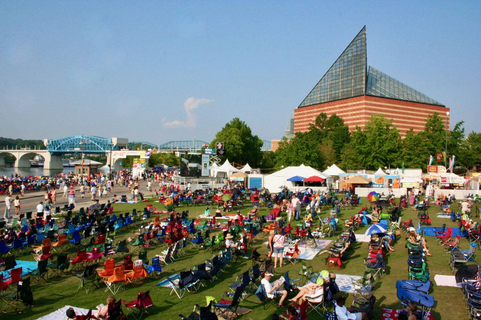 Festival crowds on the lawn at Ross's Landing beside the Tennessee Aquarium, downtown Chattanooga, where the Saturday River Market sets up on the plaza.