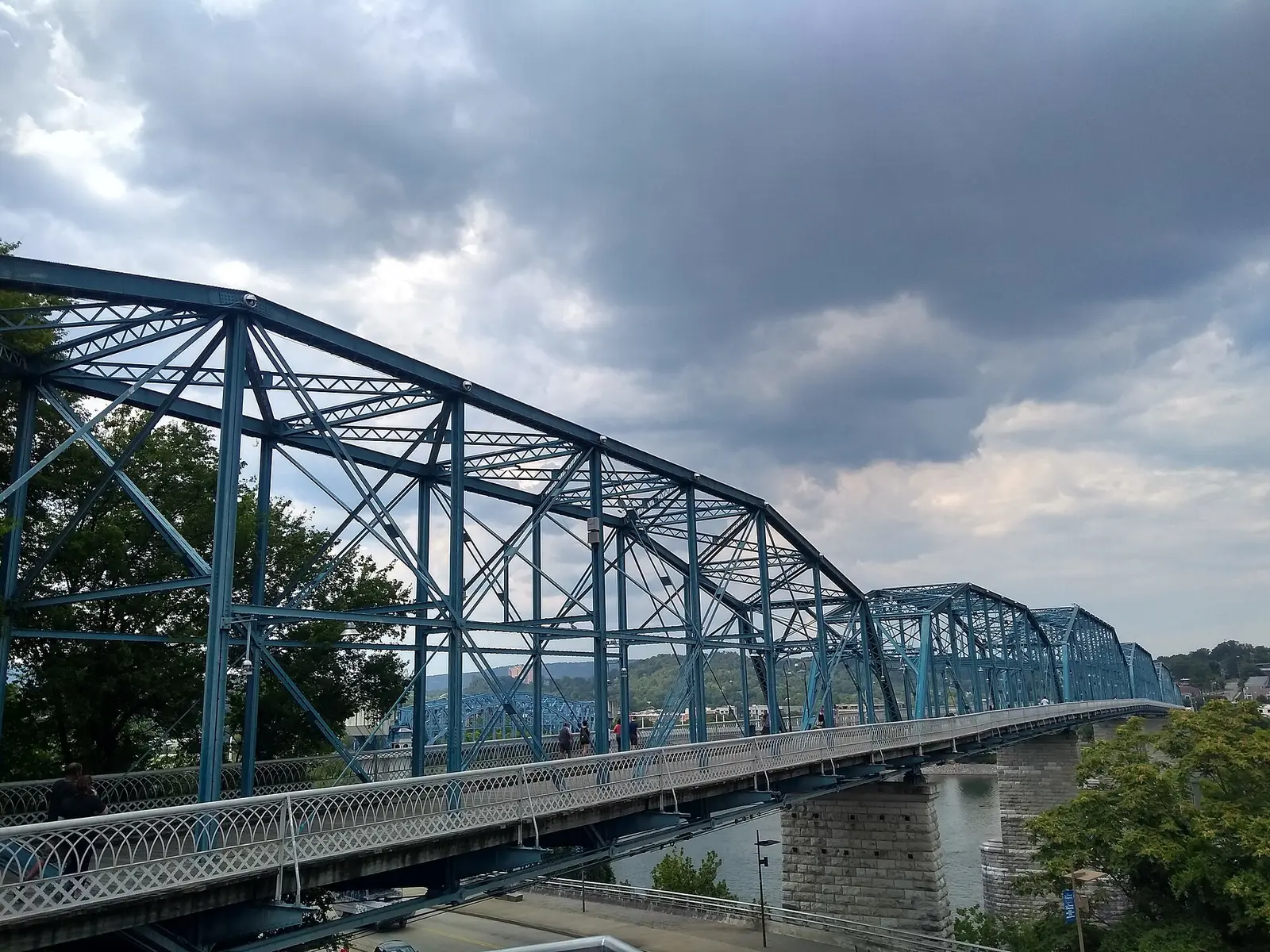 Walkers cross the blue steel trusses of the Walnut Street Bridge, the pedestrian link between downtown Chattanooga and the North Shore.